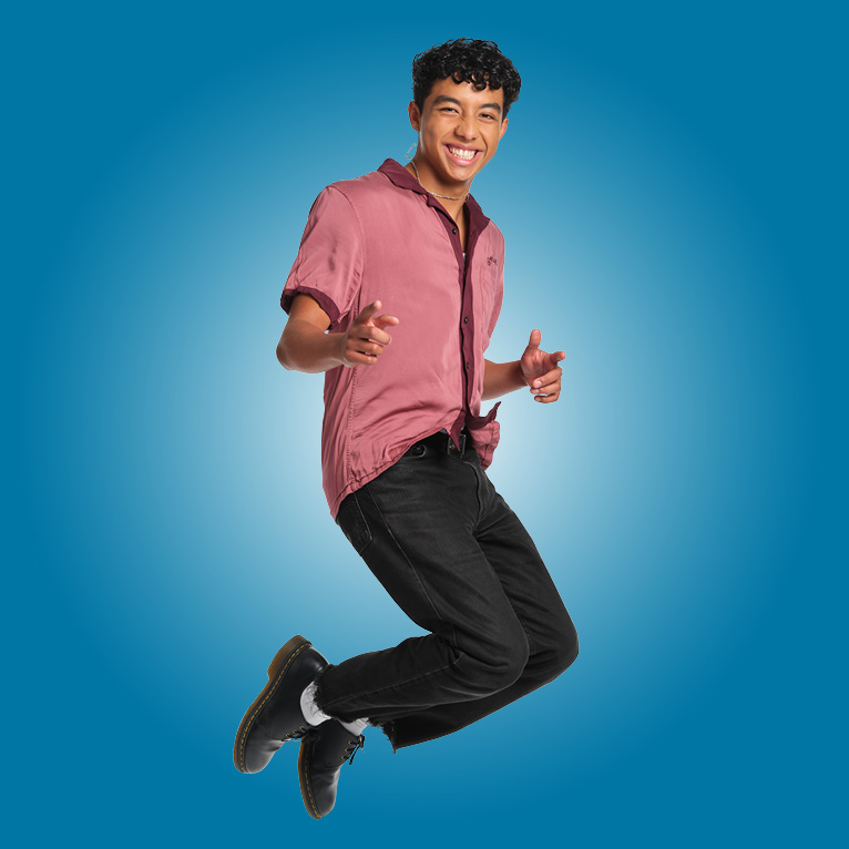 Picture of a student jumping with a blue background