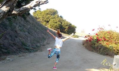 A student skipping along a hiking trail