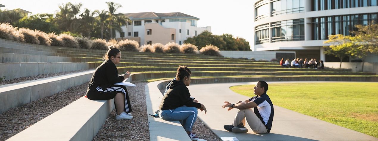 students talking near the library