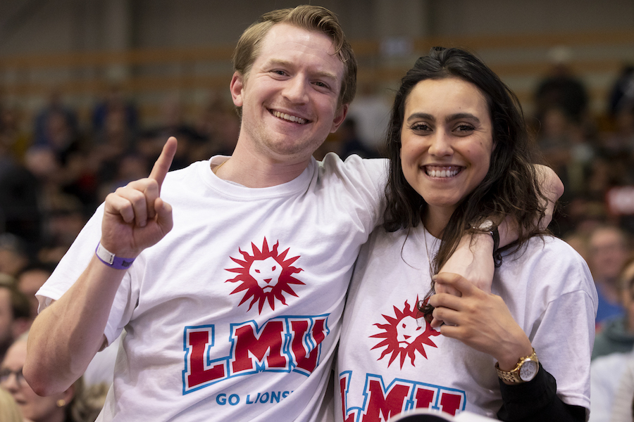 Male and female student in LMU spirit mark shirts at athletics event