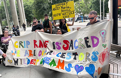 Protestors with a sign in support of ADA rights