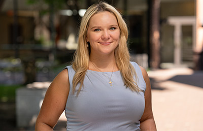 Blonde woman in a grey shirt outside