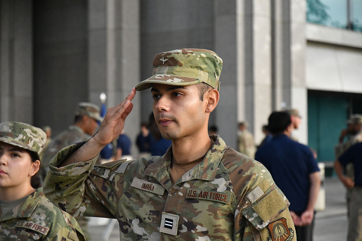 AFROTC cadets in combat attire standing in formation and saluting
