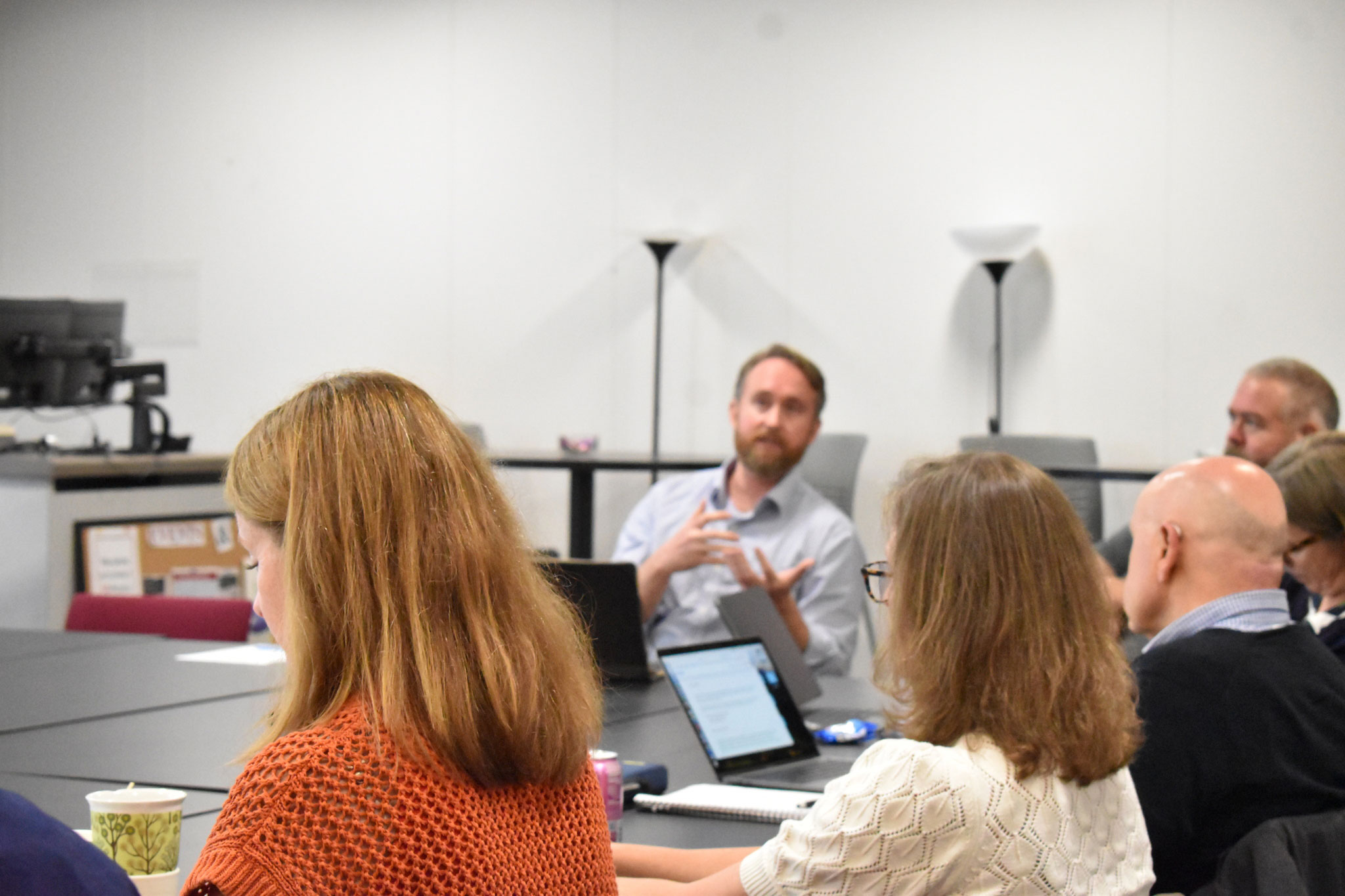 A group of faculty actively participate in a discussion