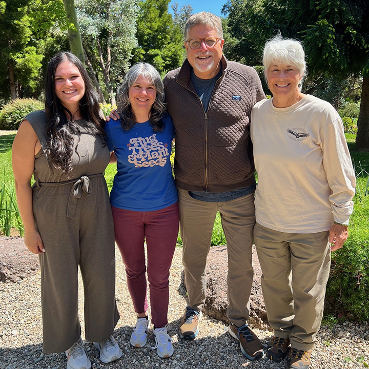 The CURes team standing in front of trees and other foliage