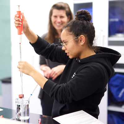 Female student working on science experiment