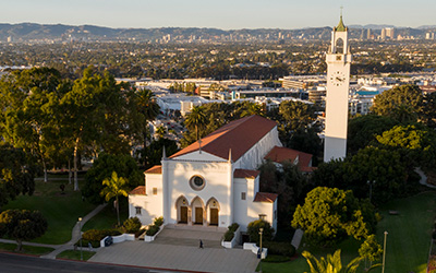 A drone shot of the Sacred Heart Chapel on a bright day.