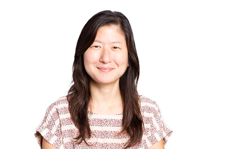 Kathleen Kim smiling in a striped shirt