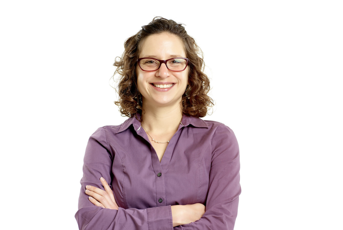 Katie Mouzakis smiling with arms folded